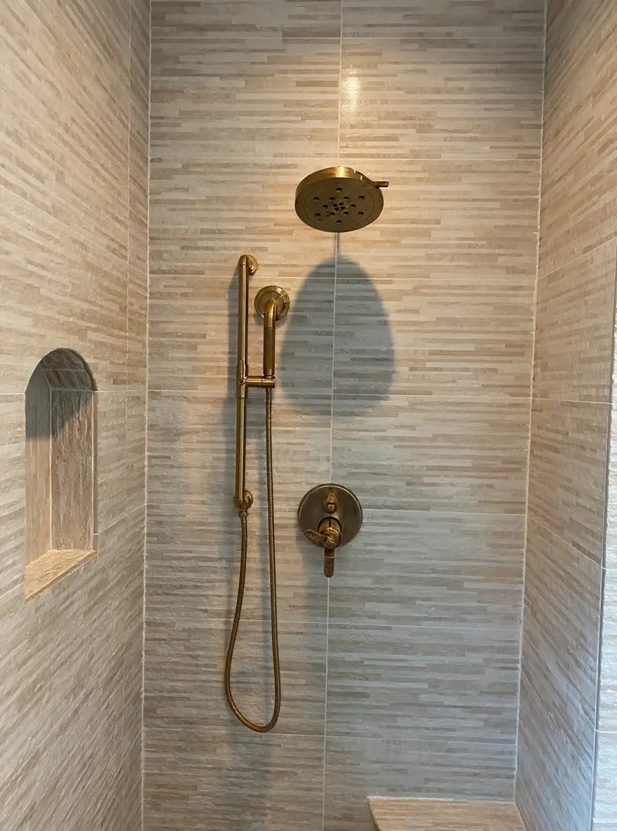 Walk-in shower with brushed-brass fixtures and stone tile