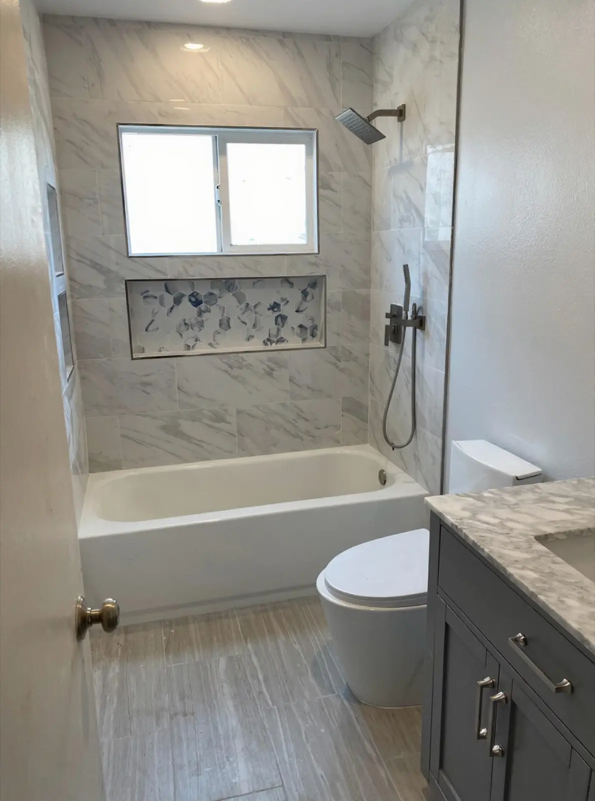 Finished marble bathroom suite with custom shower